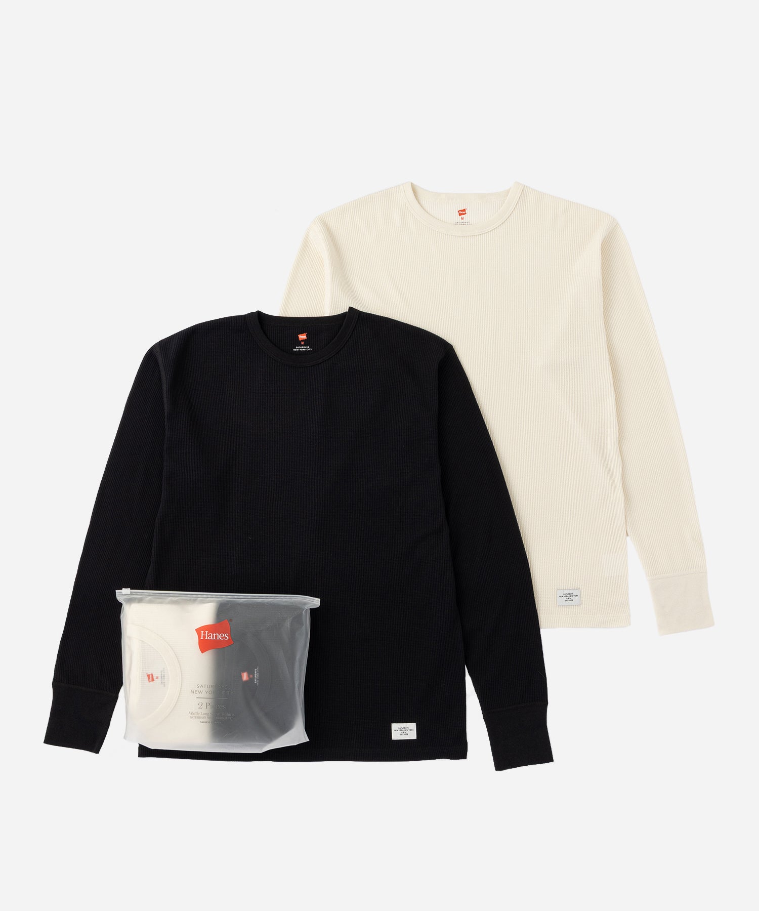 Hanes x Saturdays NYC Waffle Long Sleeve Tee 2-Pack in Black and Off White, both tees laid flat with packaging