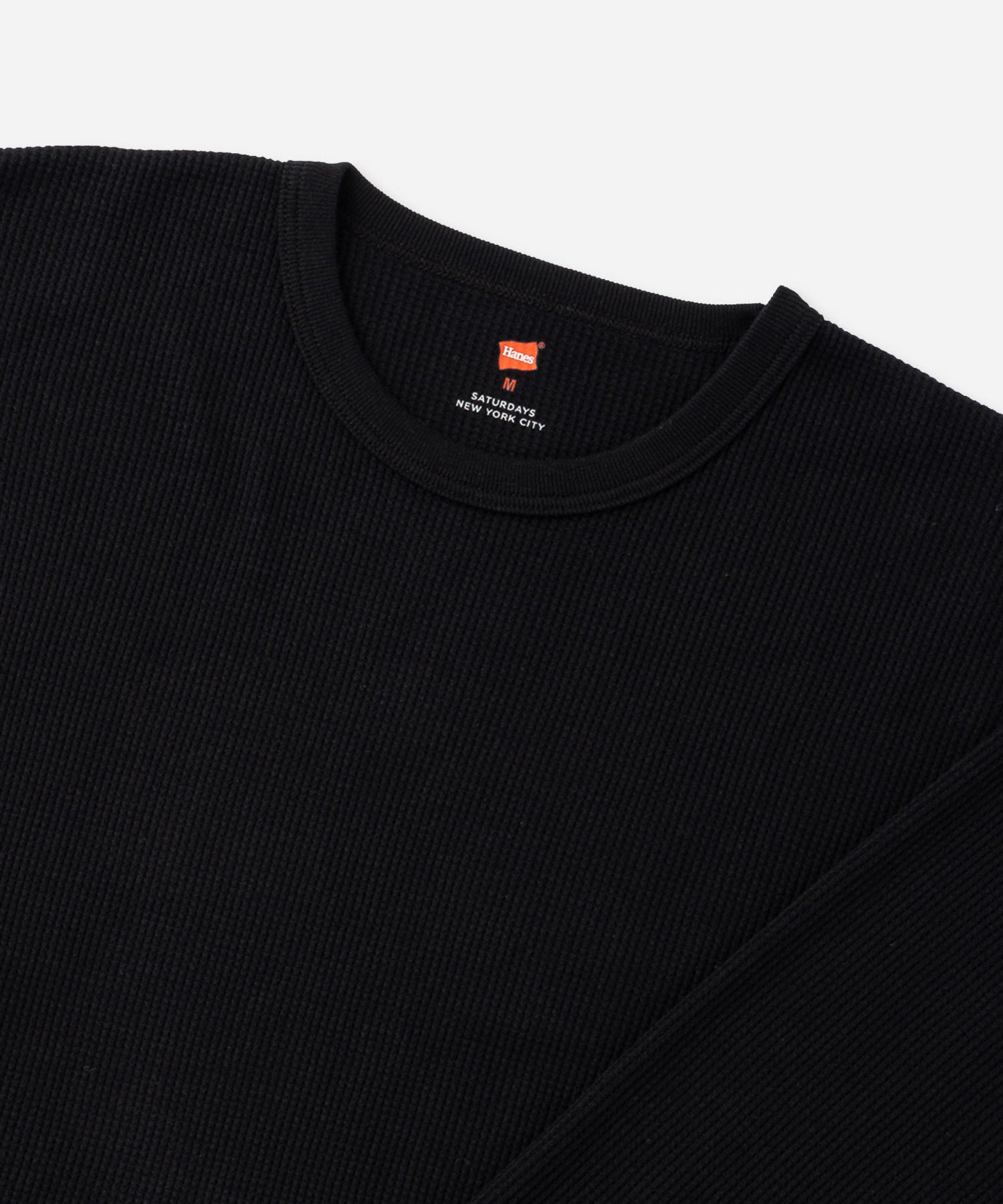 Hanes x Saturdays NYC Waffle Long Sleeve Tee in Black, close-up of waffle knit and neckline with Hanes label